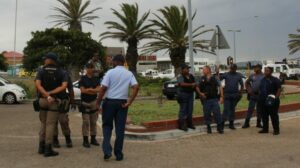 Striking workers clash with police outside hospital