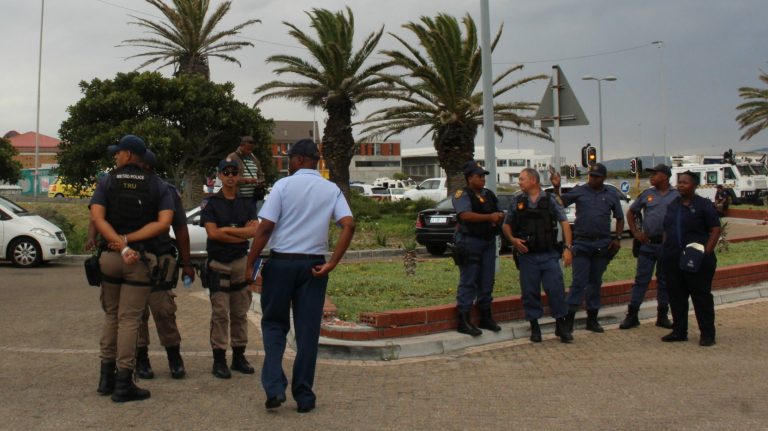 Striking workers clash with police outside hospital
